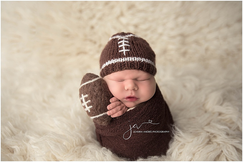 Newborn Baby Boy Holding Football