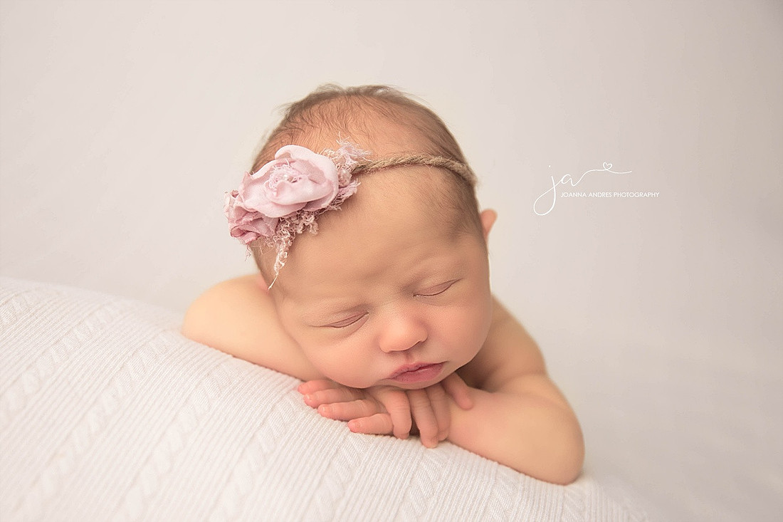 Newborn Baby girls arms folded under chin