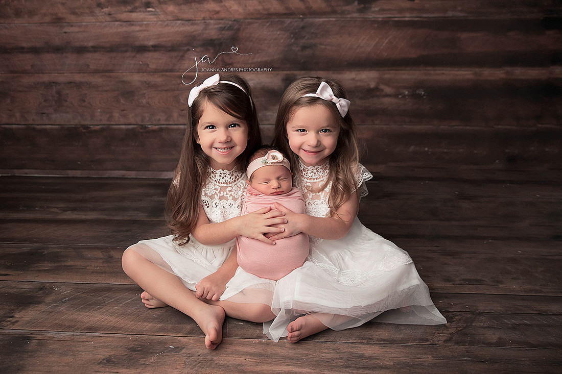 Proud Big Twin Sisters with Newborn Baby Sister
