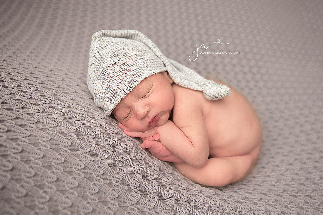 Newborn Baby Boy with legs crossed all tucked in