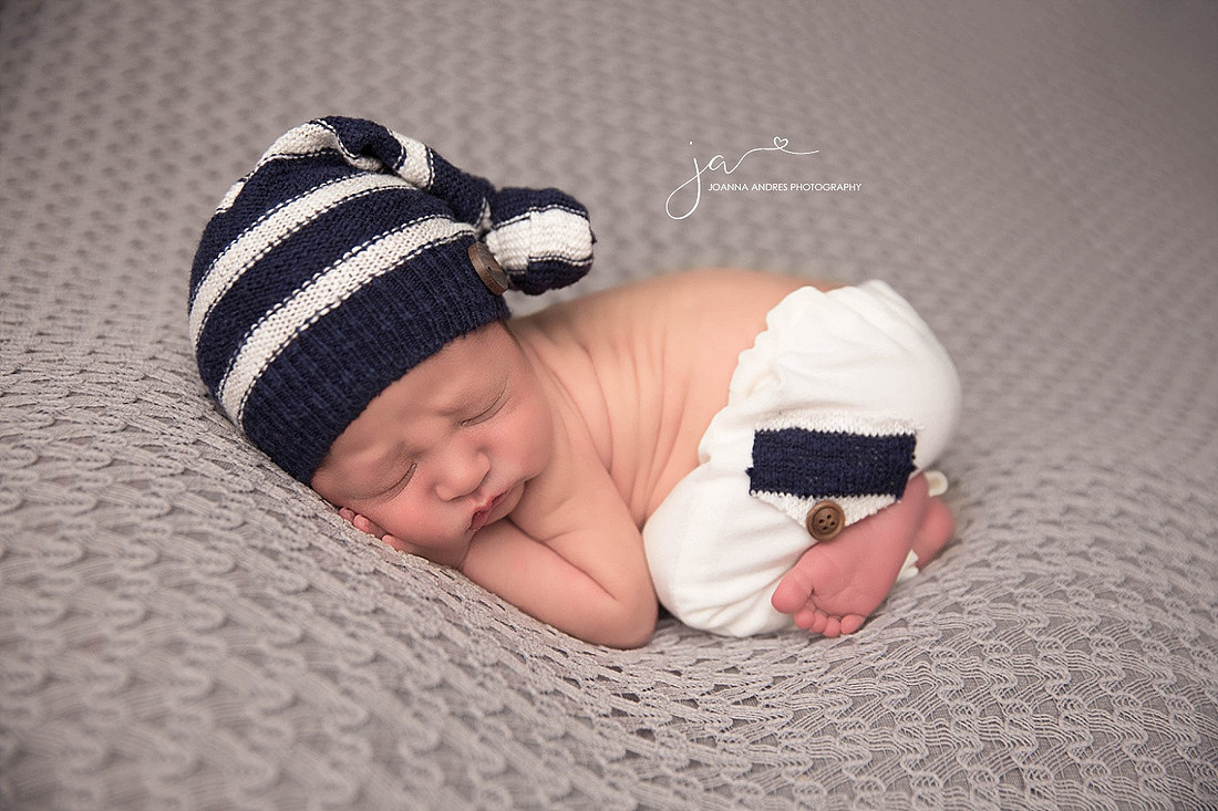 Newborn Baby Boy with Navy and White outfit and gray backdrop