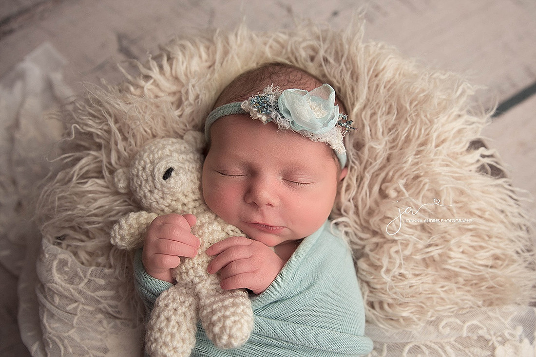 Newborn Baby GIrl in Light Blue holding teddy