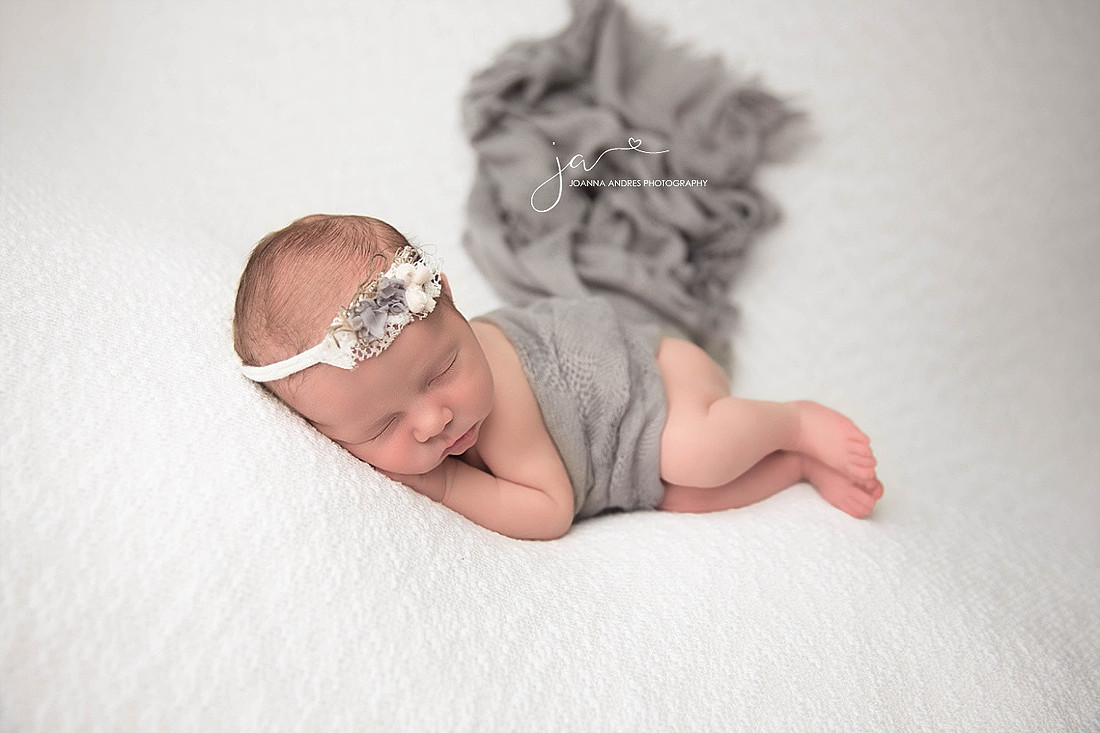 Newborn Baby Girl Side Laying Pose in Gray