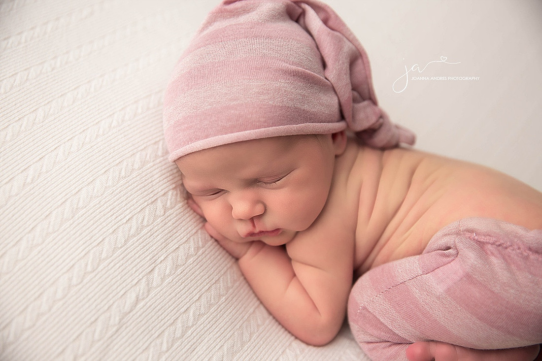 Newborn Baby Girl posed and dressed in Pinks