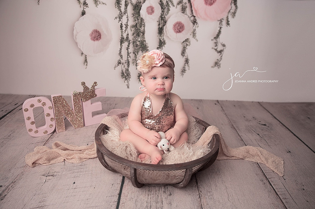 Baby Girl In Pink Sequence sitting in a basket