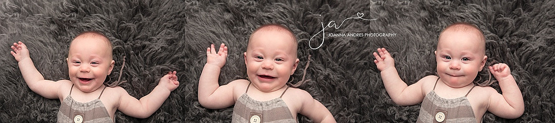 Baby boy in grays smiling