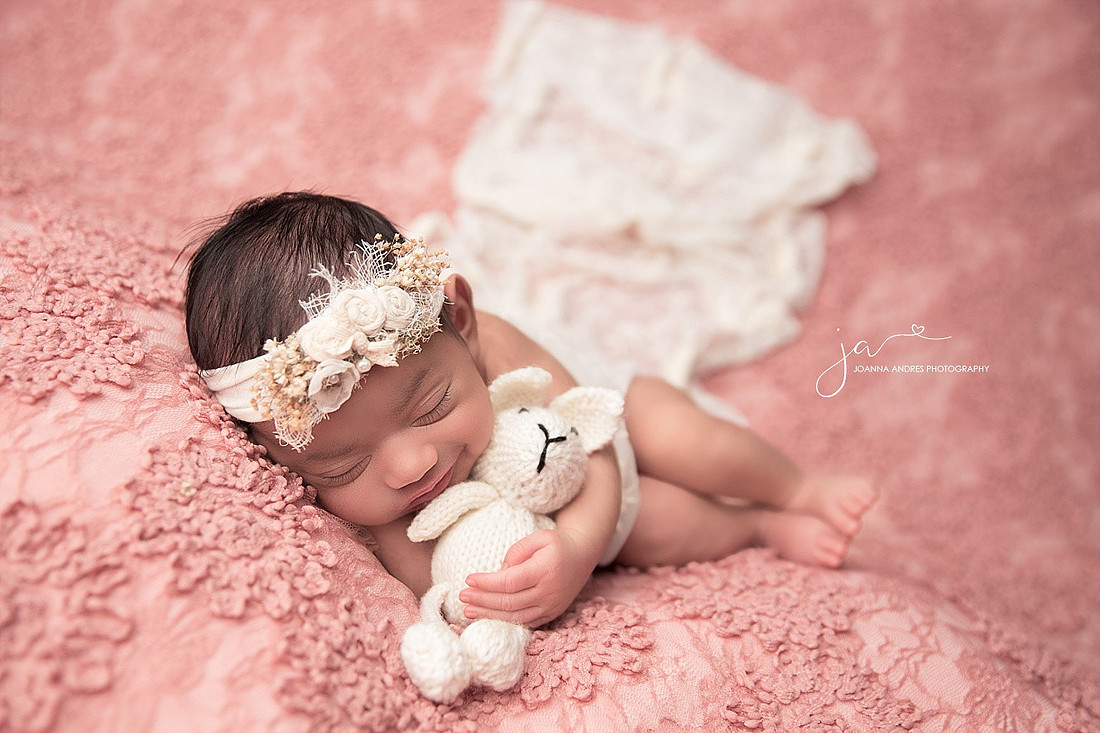 Baby girl Smiling while holding lovey