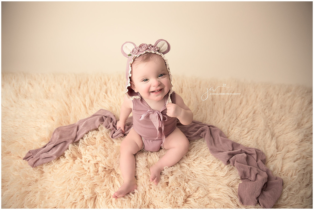 Baby Girl 9 Month GIrl Smiling In purple Romper
