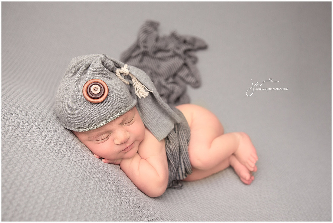 Side laying pose baby boy in grays
