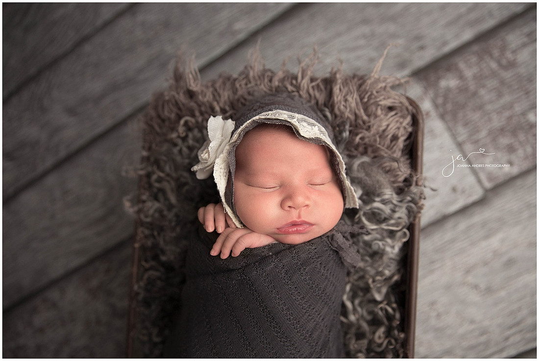Newborn Baby Girl Wrapped in Dark Grays
