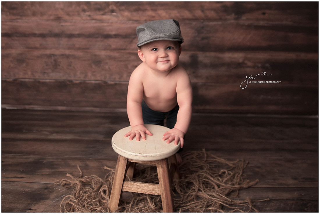 Baby Vincent One Year leaning on stool