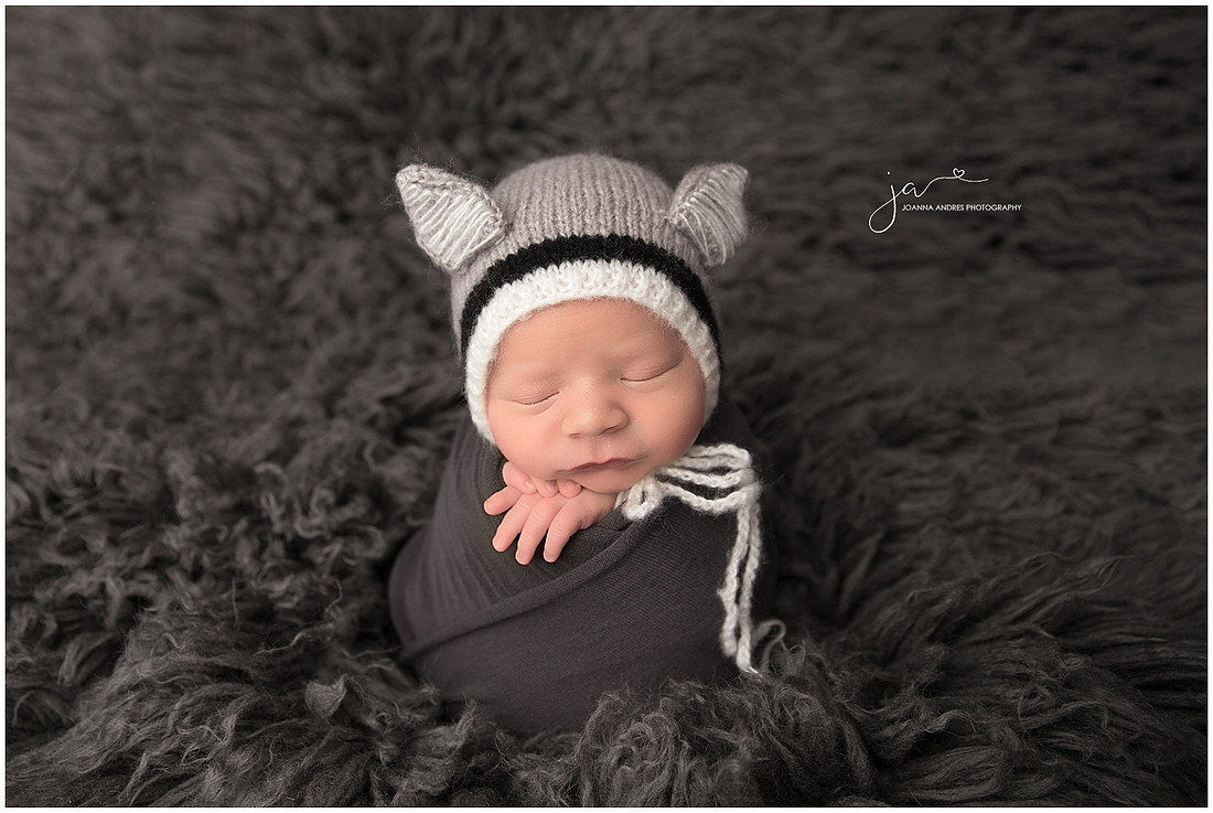 Baby Braxton in a fox hat and grays
