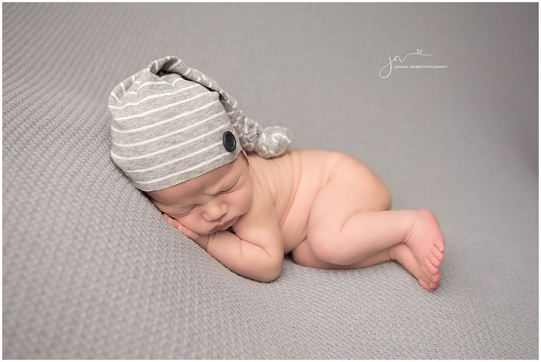 Baby Micah Side Laying Pose with Gray and White Hat