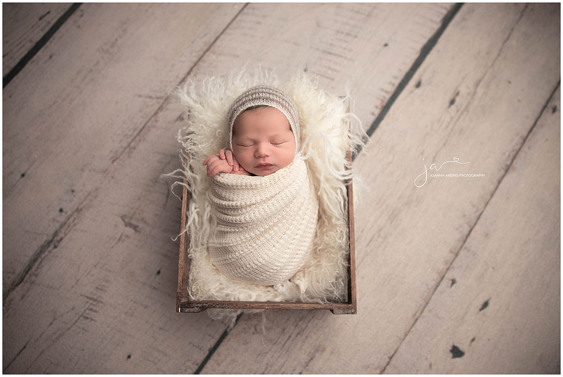 Baby In Prop Wrapped in Neutrals