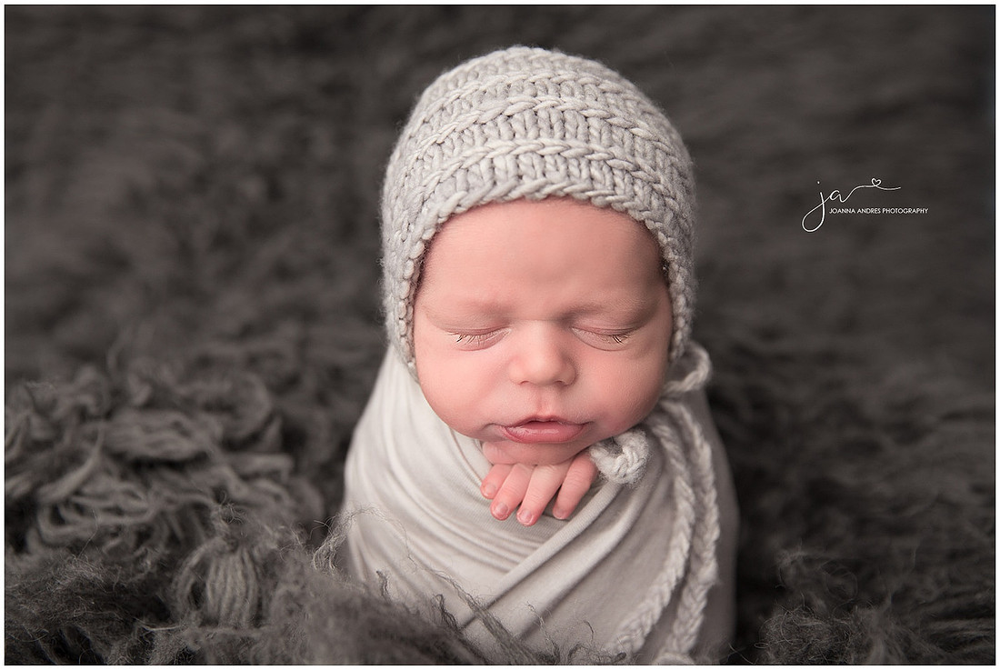 Newborn Baby Boy Wrapped in Grays