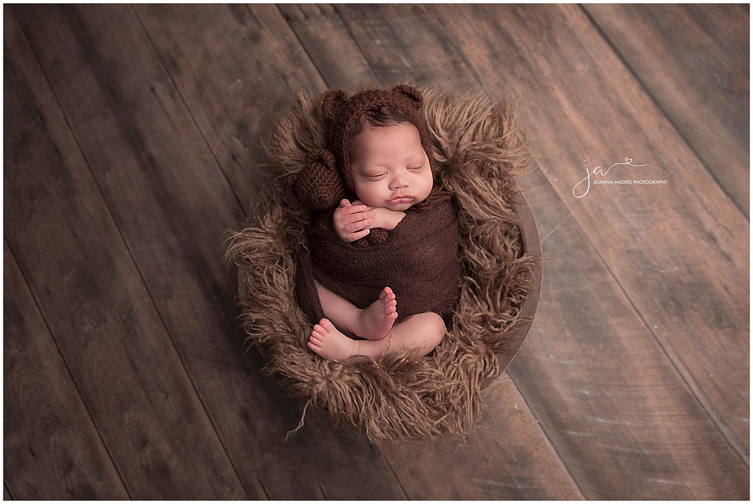 Baby Boy wrapped in Browns holding a teddy bear