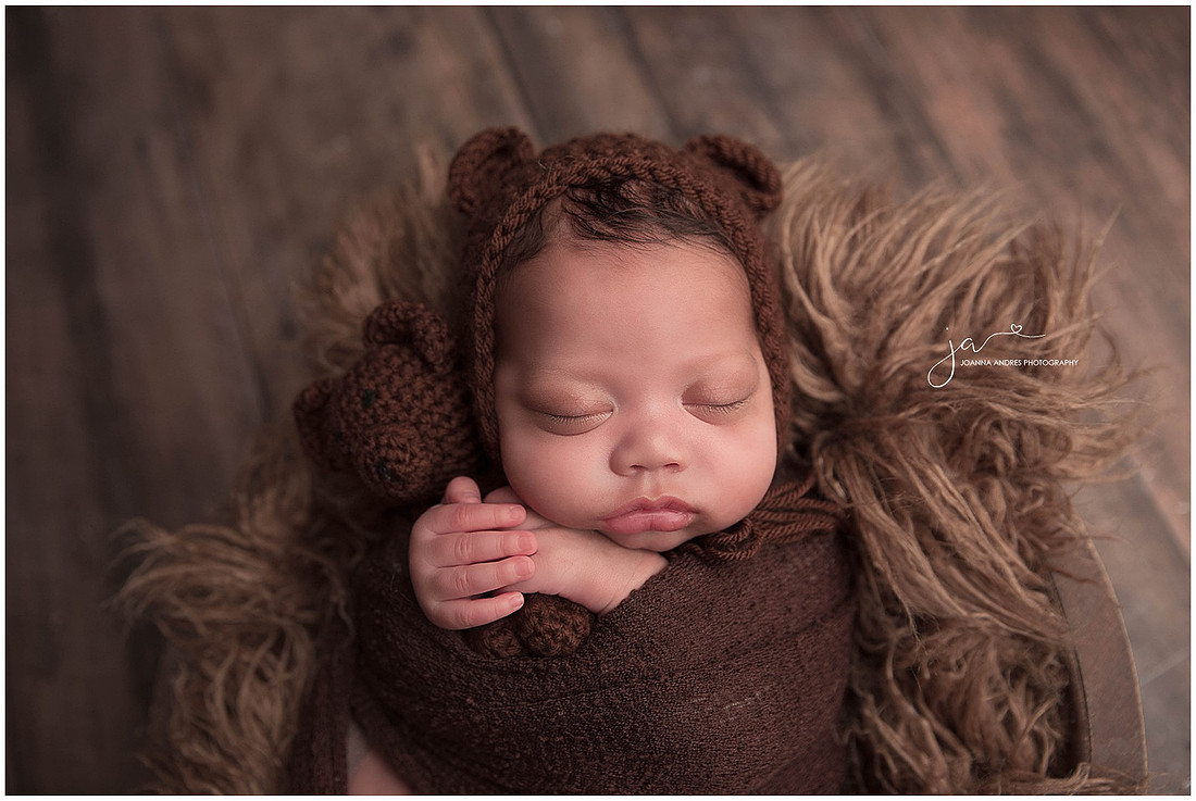 Baby Boy close up holding a teddy lovey