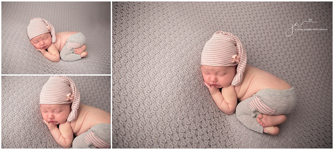 Baby girl with gray backdrop and pink and gray striped outfit