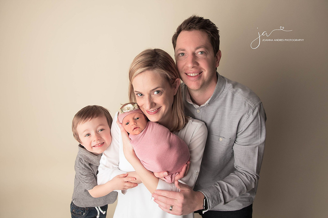 Family portrait with newborn baby, sibling and parents