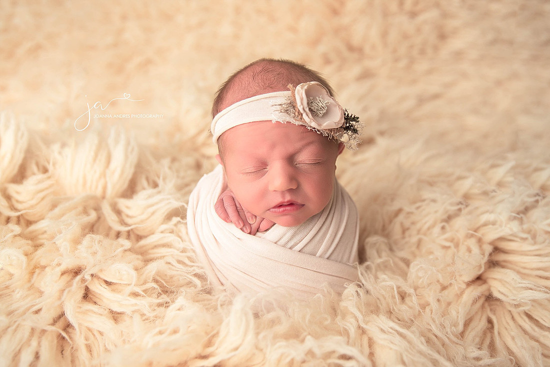 Newborn Wrapped in Neutrals and a headband