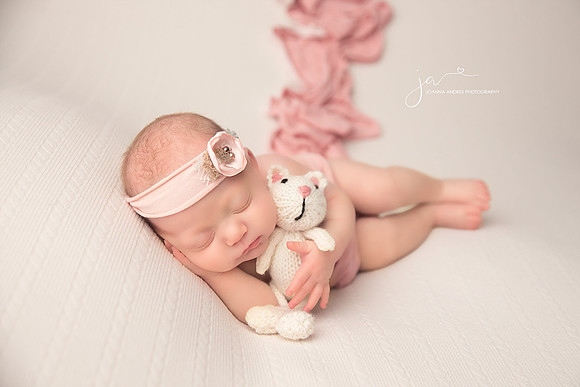 Baby Girl Side Laying Pose with Pink Wrap and white lovey