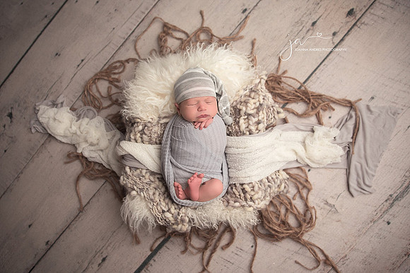 Newborn Baby Boy in Prop with jute layering wrapped in Gray