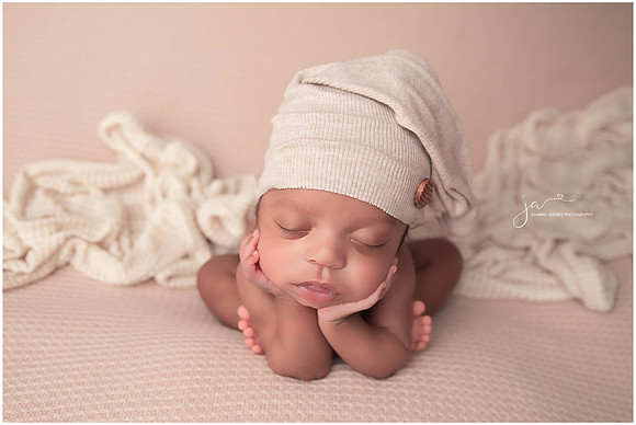 Baby in neutrals in froggy pose