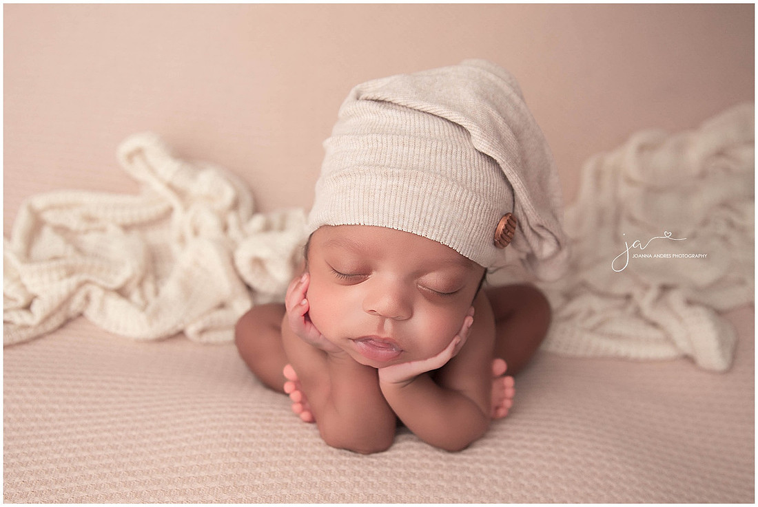 Baby in neutrals in froggy pose