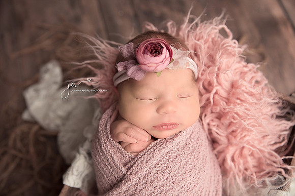 Newborn Baby Girl Wrapped in pink with flower headband