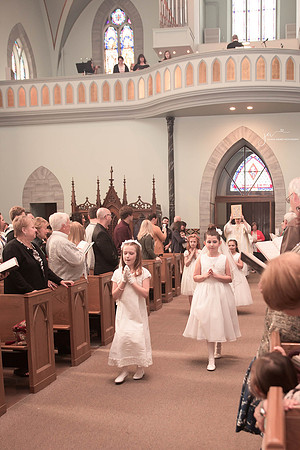 First Communion GIrl walking down isle in church