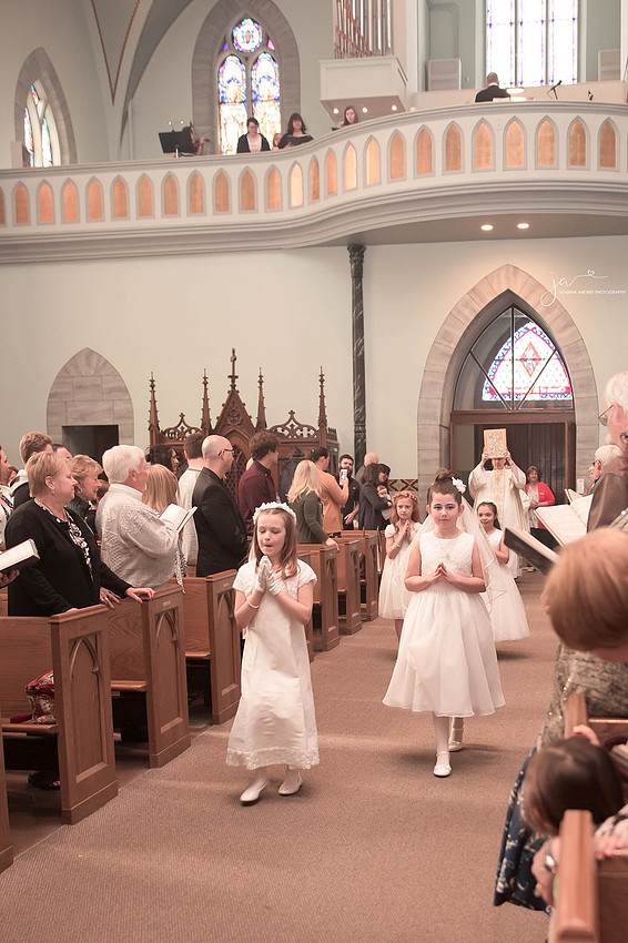 First Communion GIrl walking down isle in church