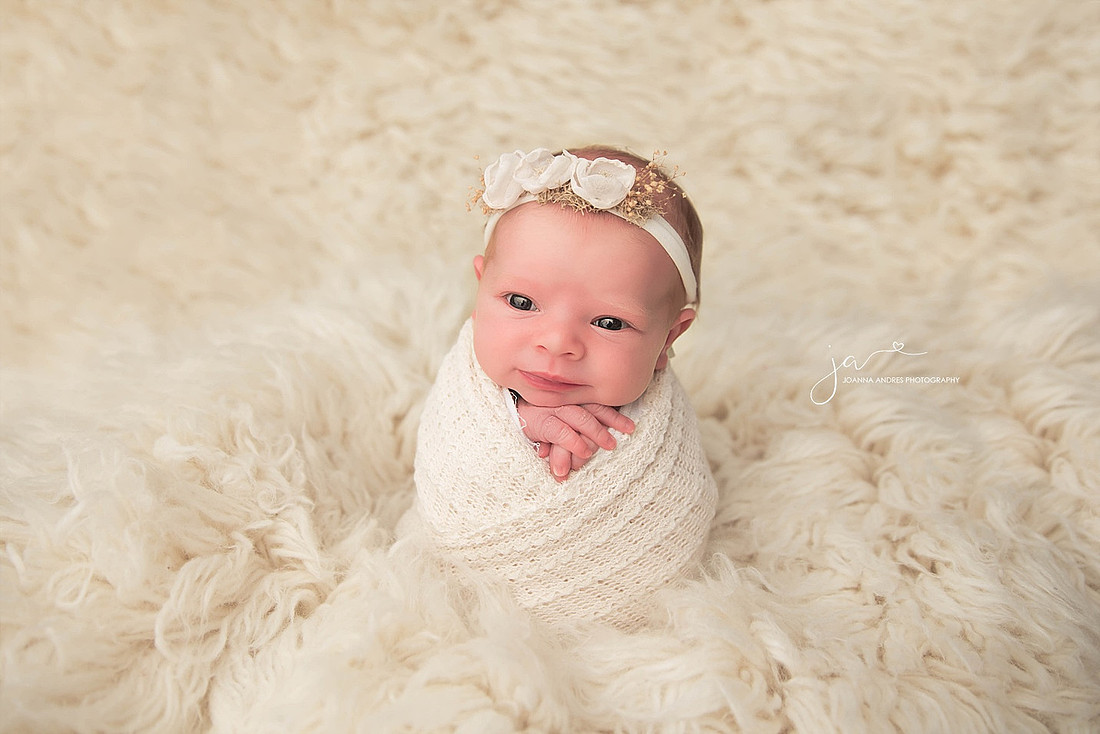Newborn Baby Girl Wide Eyed and smiling