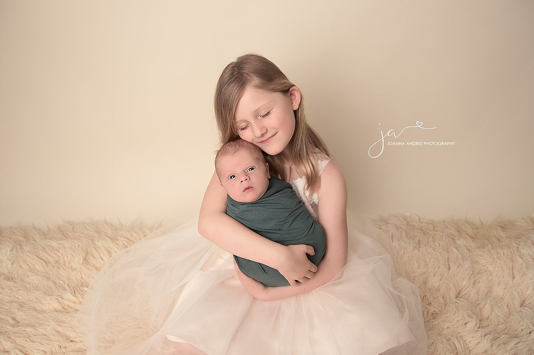 Big Sister holding baby brother