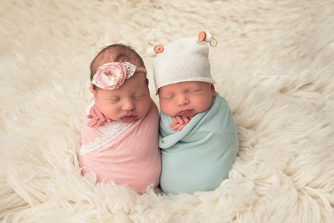 Twins boy and girl in potato sack pose in pinks and blues