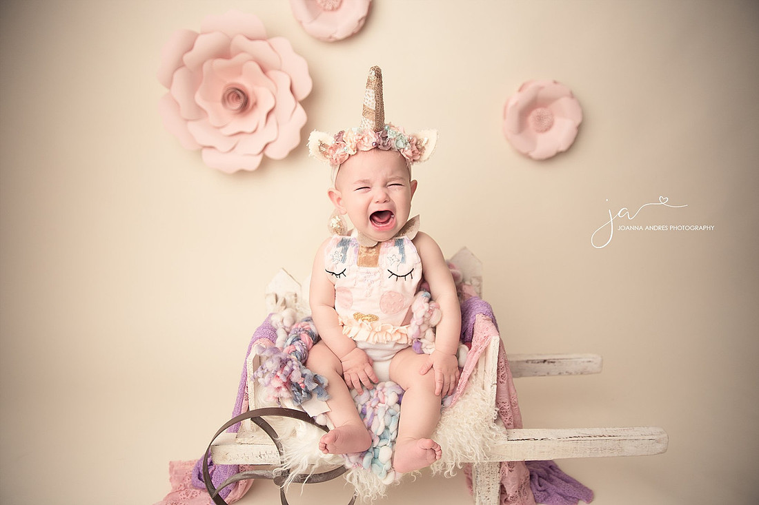 Sitting Up Session with Unicorn outfit Baby in wagon and crying