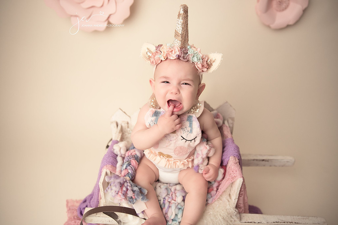 Baby Girl in unicorn outfit crying
