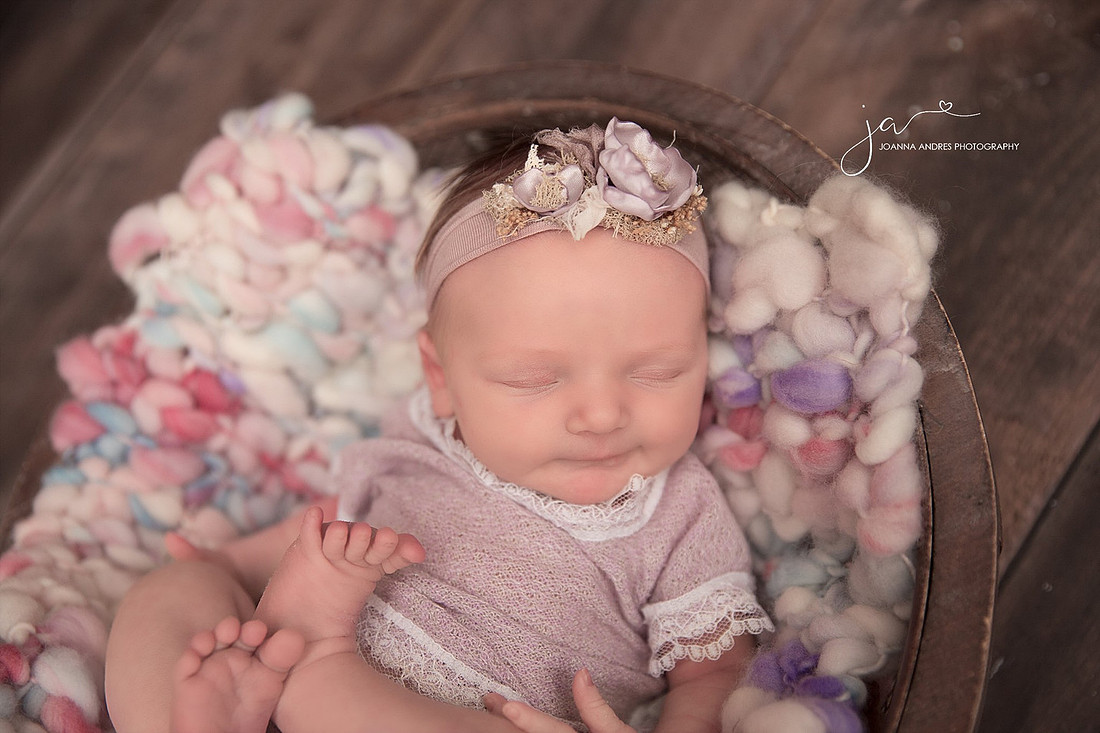 Baby Smiling wih purples, pnks and whites