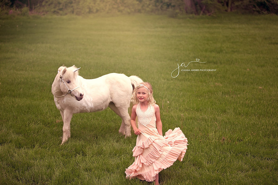 Girl Twirling in Dress with Unicorn In Backdrop