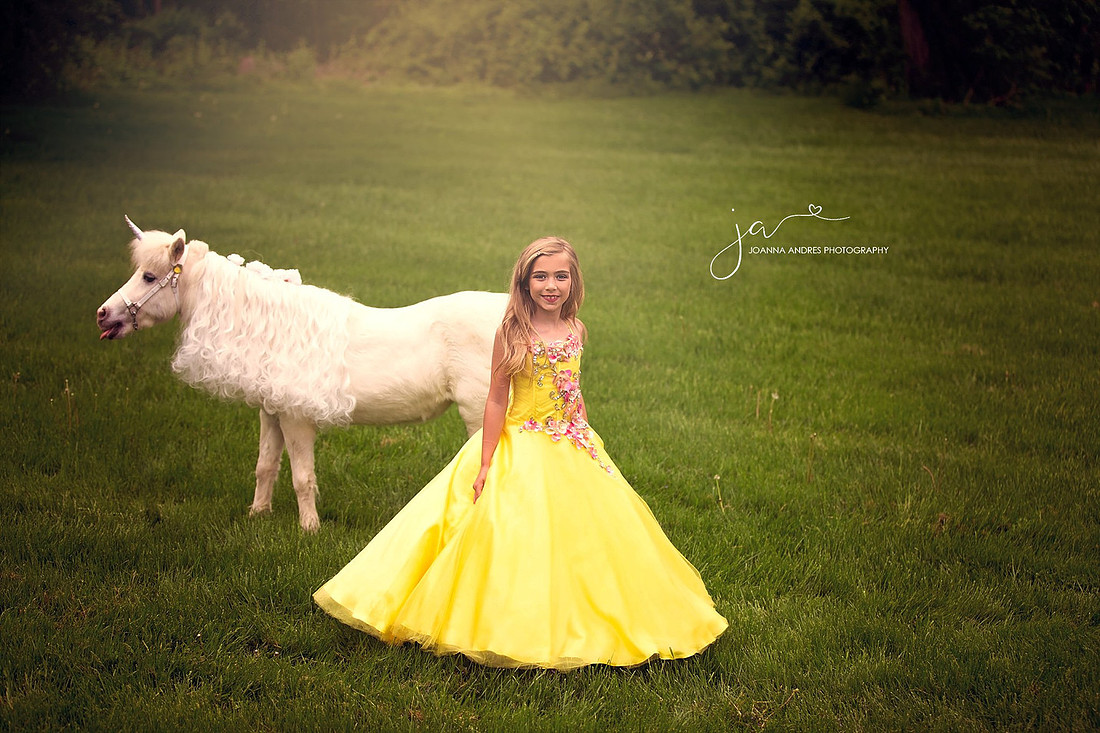 Girl standing in fornt of unicorn