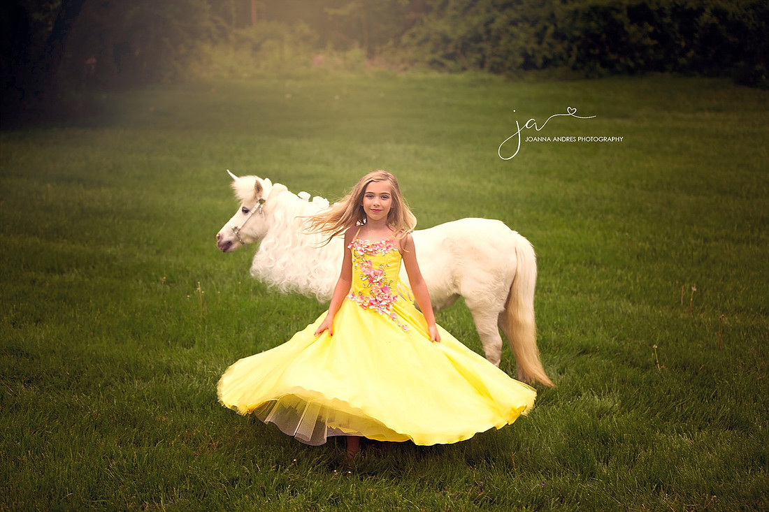 Girl twirling in front of unicorn