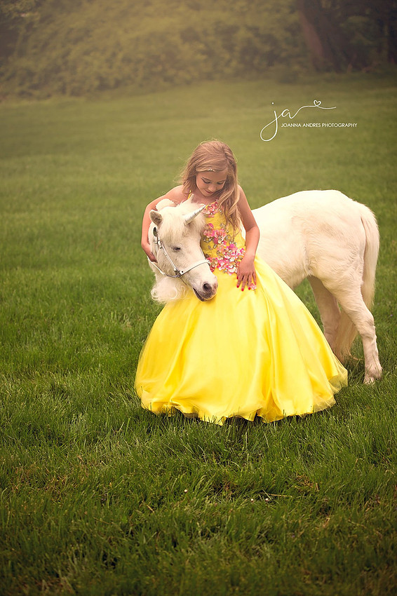 Girl looking down at unicorn