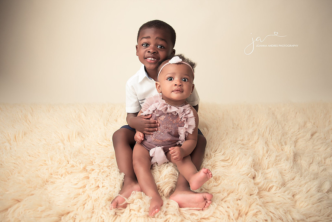 Sibling portrait big brother holding sister