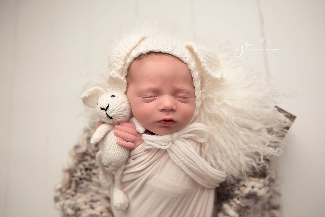 Baby Girl in WHites holding lovey
