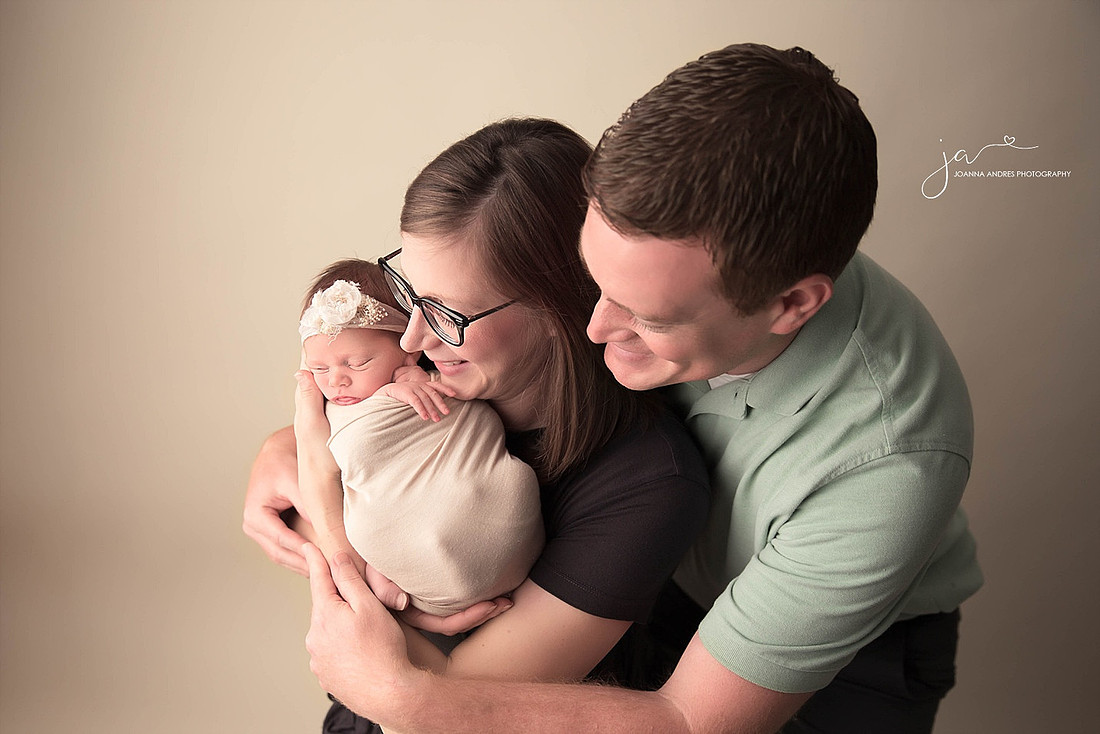 Family shot looking at baby