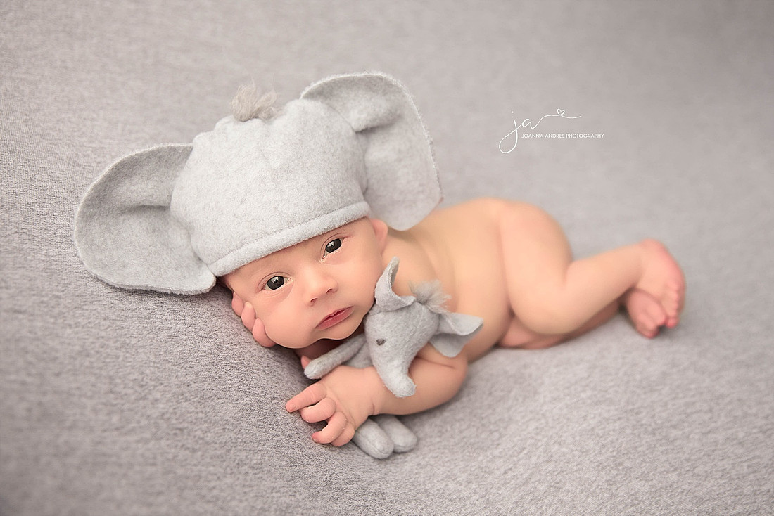 Baby Boy in Elephant Hat SIde Laying with Eyes Open