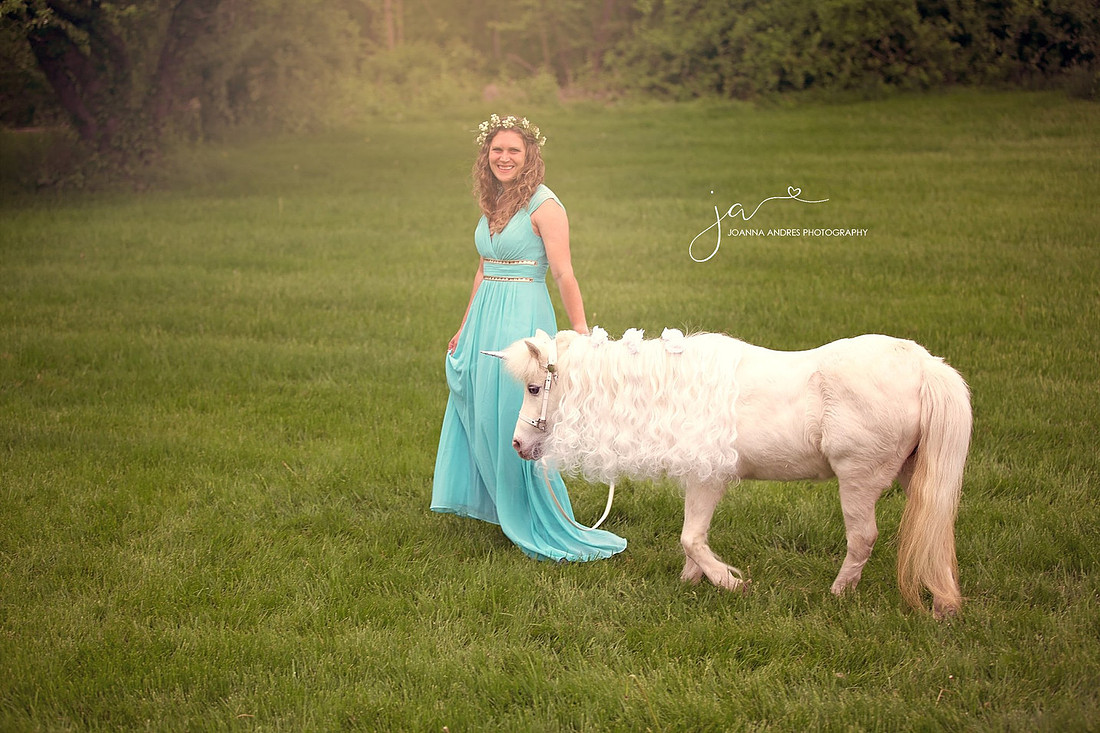 Lady in a blue dress with a unciorn