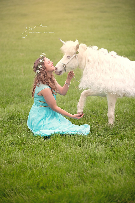 Unicorn Shaking hands with woman dressed in blue
