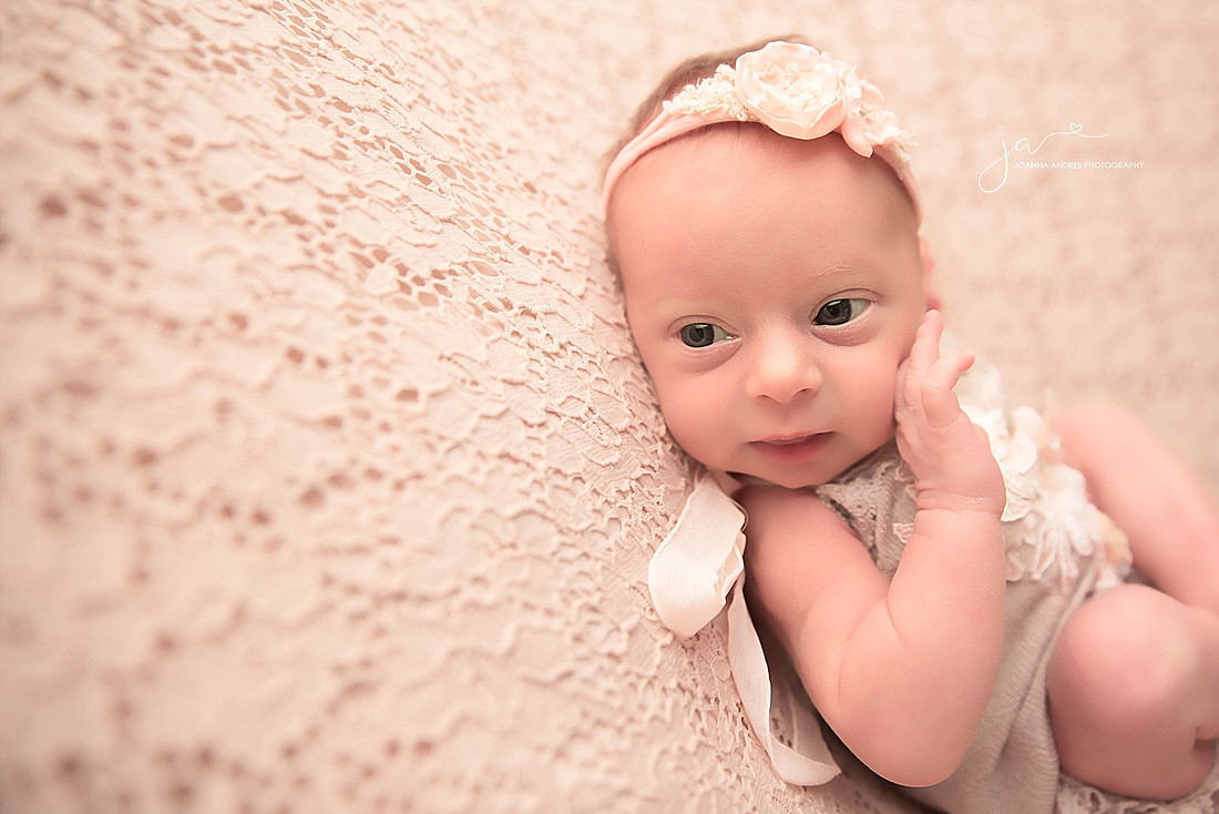 Baby with hands on face