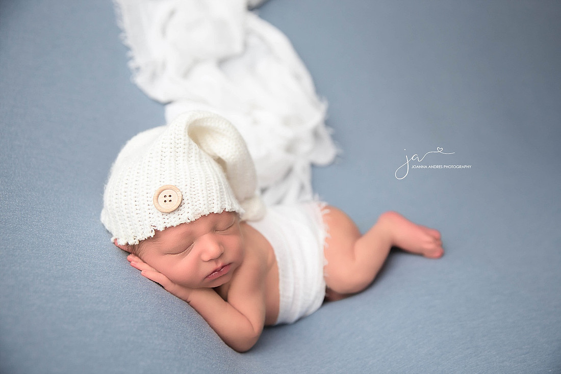 Side laying pose of Baby with Blues and Whites