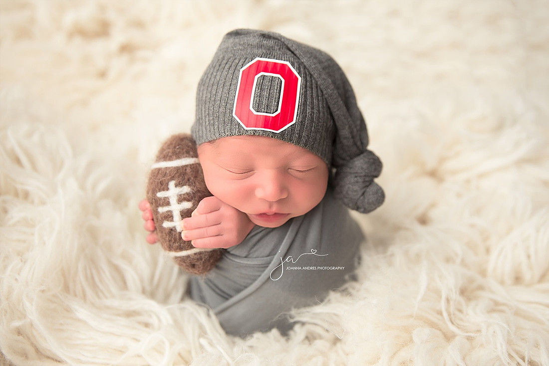 Buckeye Baby Holding football sleeping